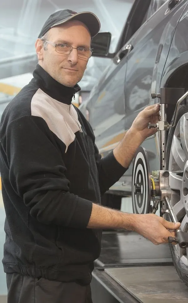 Technician checking a car wheel