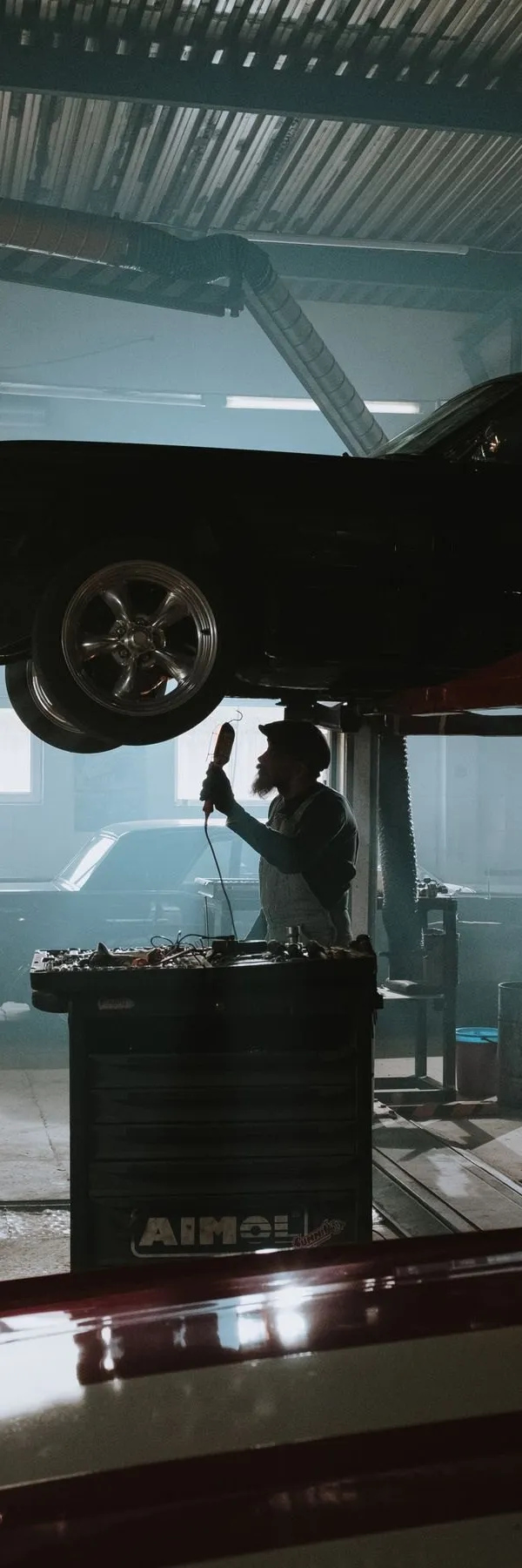 Car on a lift in a tyre service bay